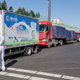 A staff member wearing protective gear speaks with a truck driver at an exit of a highway in Jilin in China’s Jilin province on May 13, 2020.